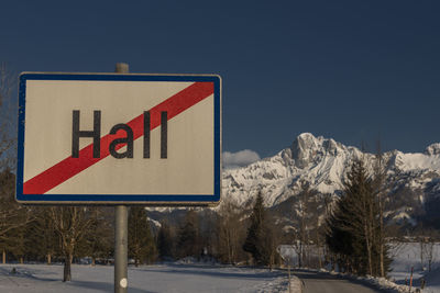 Low angle view of road sign against sky