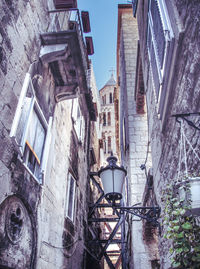 Low angle view of street light against building