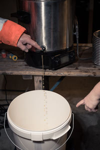 Midsection of person working in kitchen