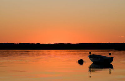 Boat in sunset in lake finjasjön, sweden. this lake is located near the city of hässleholm in skåne.