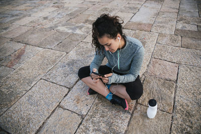 Athletic young woman with mobile phone