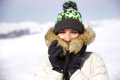 Portrait of man wearing hat against sky during winter