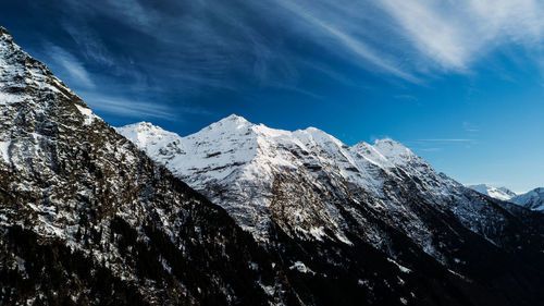 Scenic view of snowcapped mountains against blue sky