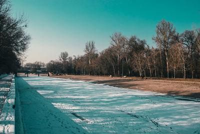 Snow covered field against sky