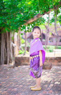 Portrait of a smiling girl standing outdoors