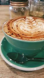 Close-up of cappuccino served on table