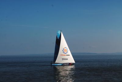 Sailboat on sea against sky