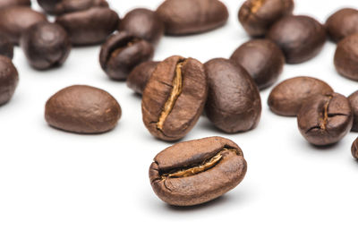 Close-up of coffee beans against white background