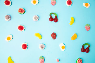 Full frame shot of multi colored candies against blue background