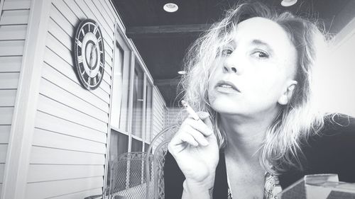 Portrait of young woman smoking