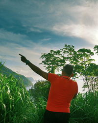 Rear view of man standing by trees