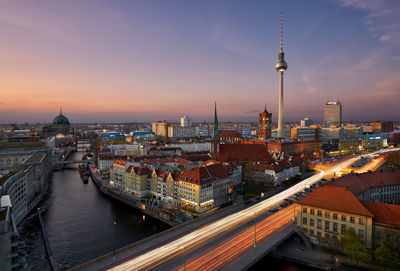 High angle view of berlin city lit up at sunset