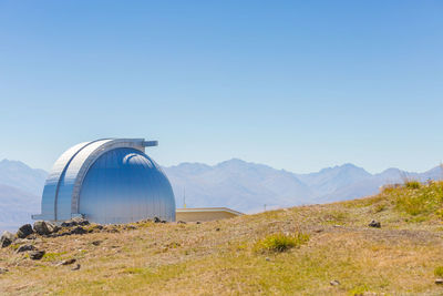 Scenic view of land against clear blue sky