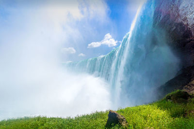 Panoramic view of waterfall against sky