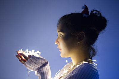 Side view of young woman drinking glass