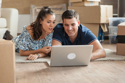 Young woman using laptop at home