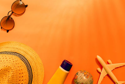 High angle view of electric lamp on table against orange wall