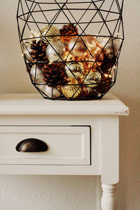 Close-up of electric lamp on wall at home