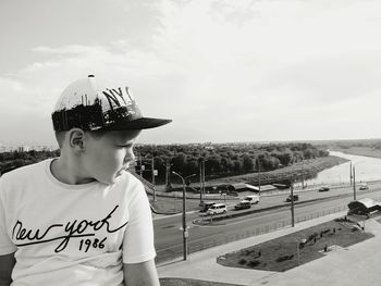 Boy looking at camera against sky