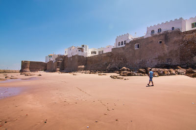 Man standing on fort against clear sky