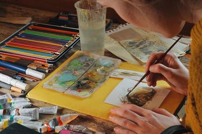 Close-up of woman painting watercolors