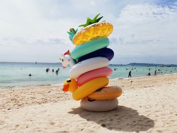 Multi colored umbrella on beach against sky