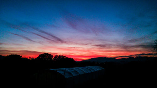 Scenic view of silhouette mountains against sky at sunset