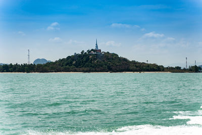 Scenic view of sea by building against sky