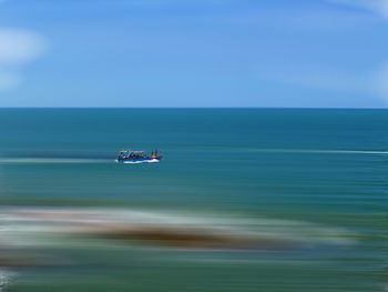 Scenic view of sea against blue sky