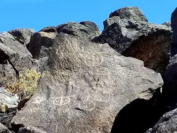 Low angle view of rocks against sky