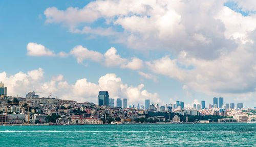 Scenic view of sea and buildings against sky