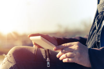 Midsection of man holding digital tablet 