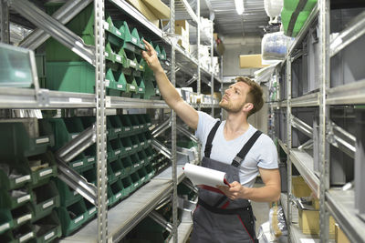 Man in warehouse looking in box