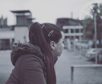 Side view of woman with long hair looking away