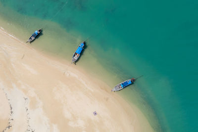 Long tail boat on the sand beach in island kra bi thailand aerial view