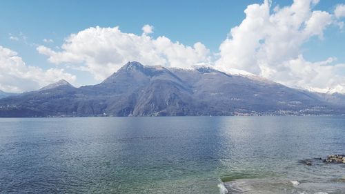 Scenic view of lake by mountains against sky