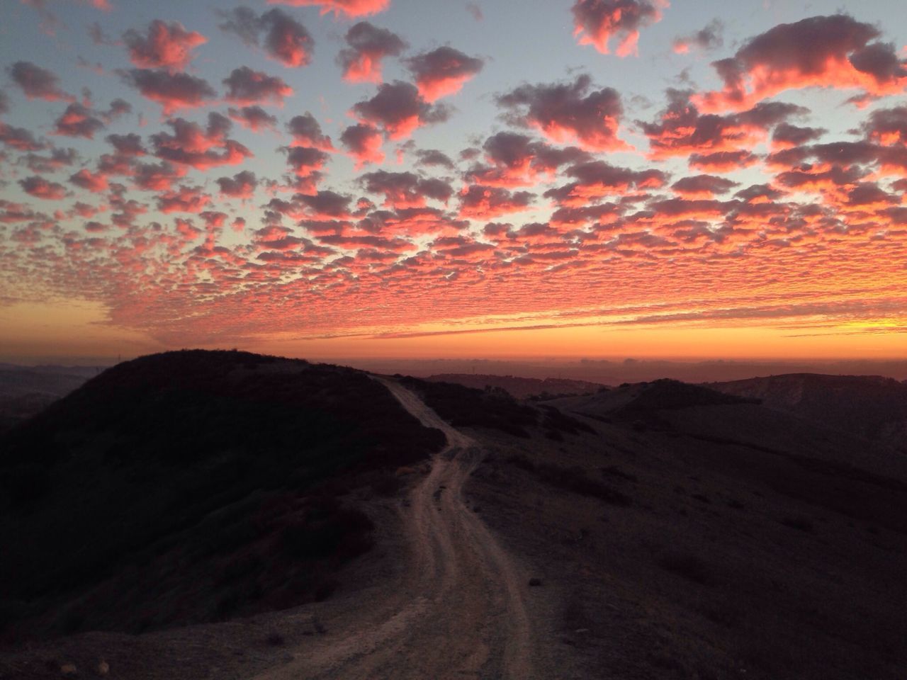 sunset, tranquil scene, scenics, tranquility, beauty in nature, landscape, orange color, sky, nature, idyllic, the way forward, non-urban scene, desert, cloud - sky, road, mountain, remote, dramatic sky, sand, outdoors