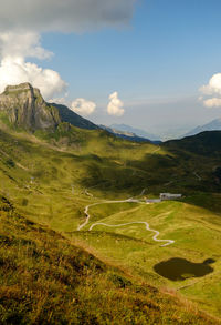 Scenic view of landscape against cloudy sky