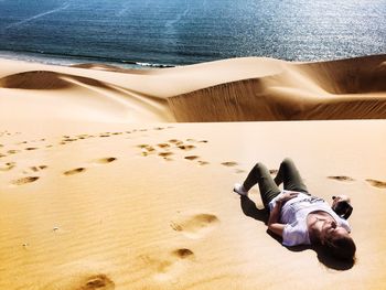 Two people relaxing on beach
