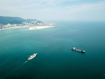 Aerial view of ships in sea against sky