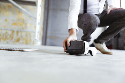 Architect taking virtual reality glasses at construction site