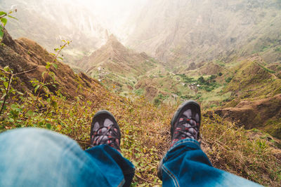 Low section of man relaxing on mountain