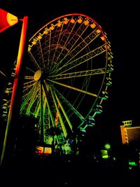 Low angle view of ferris wheel against sky at night