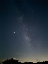 Low angle view of silhouette trees against sky at night