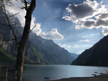 Scenic view of lake and mountains against sky