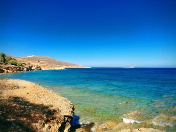 Scenic view of sea against clear blue sky