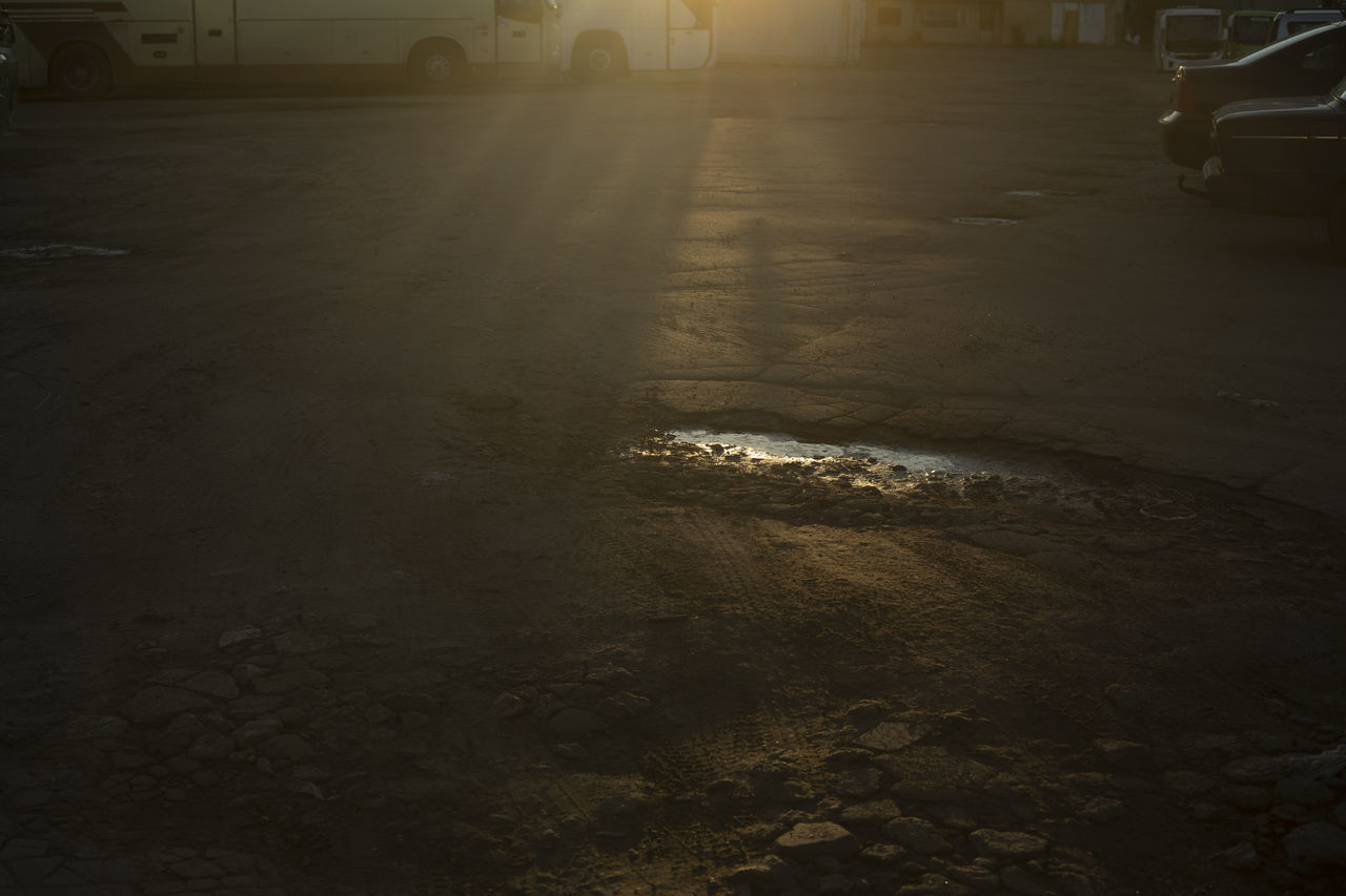 darkness, morning, light, car, motor vehicle, transportation, night, mode of transportation, city, street, architecture, land vehicle, nature, road, reflection, no people, black, built structure, building exterior, outdoors, wet, vehicle