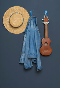 Close-up of guitar against blue wall