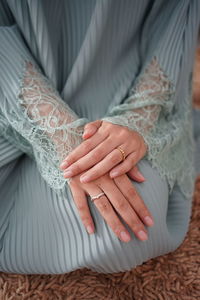 Midsection of woman holding hands