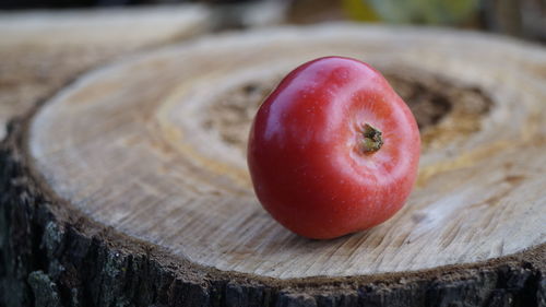 Close-up of apple on tree stump